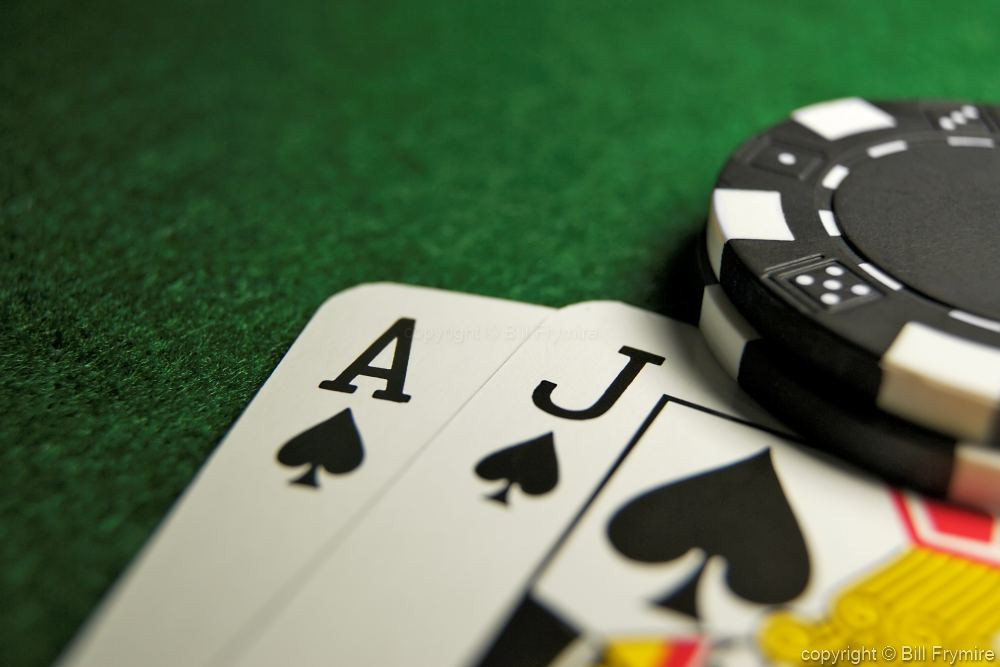 blackjack hand with poker chips on top